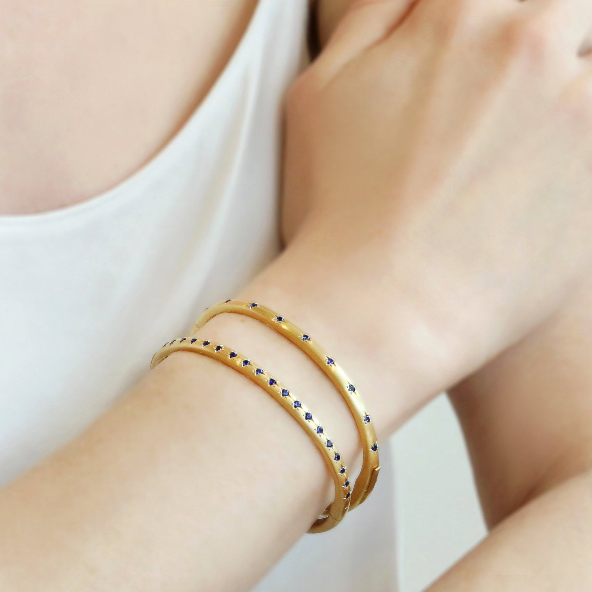 Caroline Ellen Gold and Double Sided Star-Set Blue Sapphire Hinged Bangle