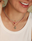 Faceted Oval Aquamarine Pendant Necklace with 18K Bezel - Set Teardrop Diamond Detail on Brown Cord - Peridot Fine Jewelry - Margaret Solow Jewelry