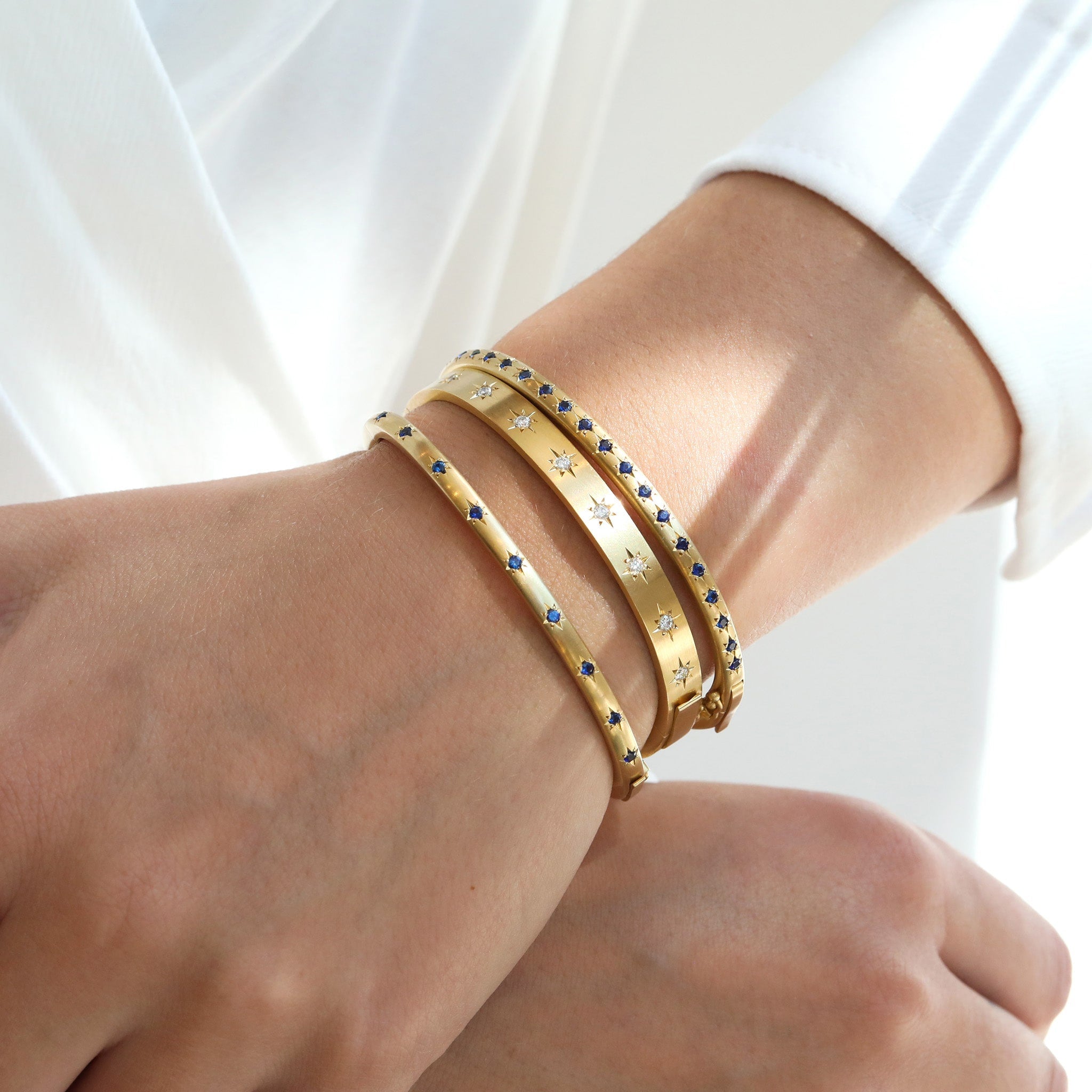 Caroline Ellen Gold and Double Sided Star-Set Blue Sapphire Hinged Bangle